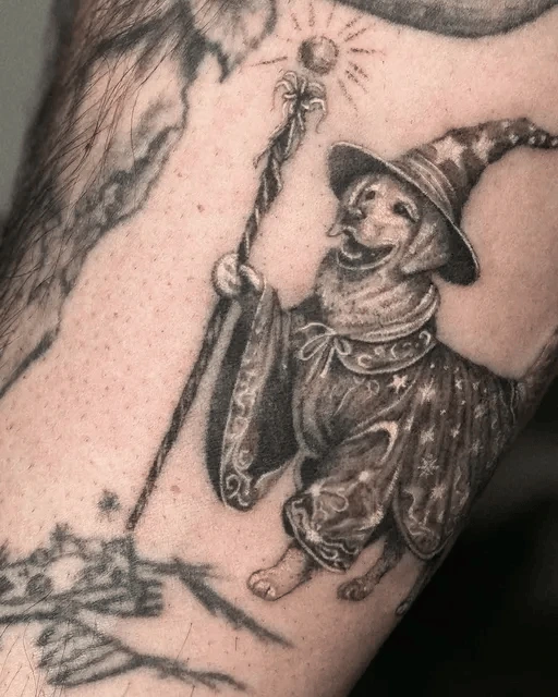 wizard dog tattoo with staff and star robe on arm